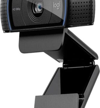 The image features the Logitech C920x HD Pro Webcam, which is designed to enhance digital interactions. The webcam has a sleek, rectangular black body with curved edges and a glass lens in the center. On either side of the lens, there are small