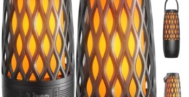 Outdoor speakers on a patio with lush greenery, perfect for lively event ambiance.
