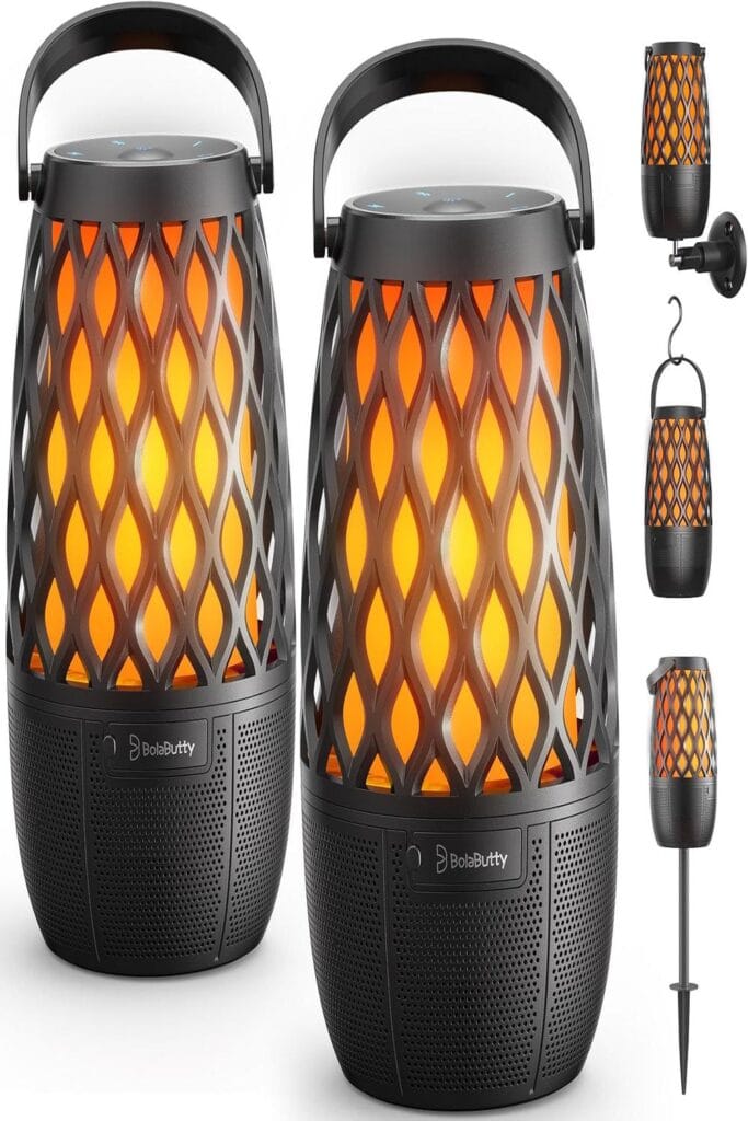 Outdoor speakers on a patio with lush greenery, perfect for lively event ambiance.