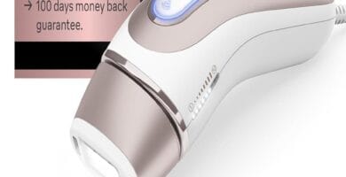 Braun IPL Skin i·expert device with festive holiday decorations in the background.