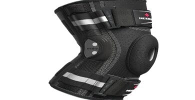 Knee brace with support straps and breathable fabric for enhanced fitness performance.