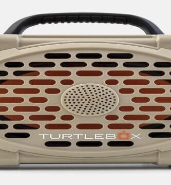 Speaker and backpack set against a scenic outdoor backdrop.